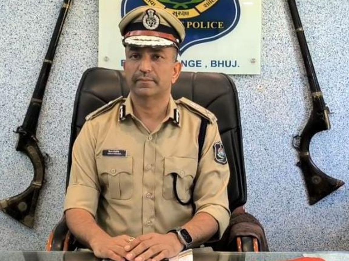 Chirag Koradia in police uniform, seated at his desk in the Border Range office at Bhuj beneath the range signboard.